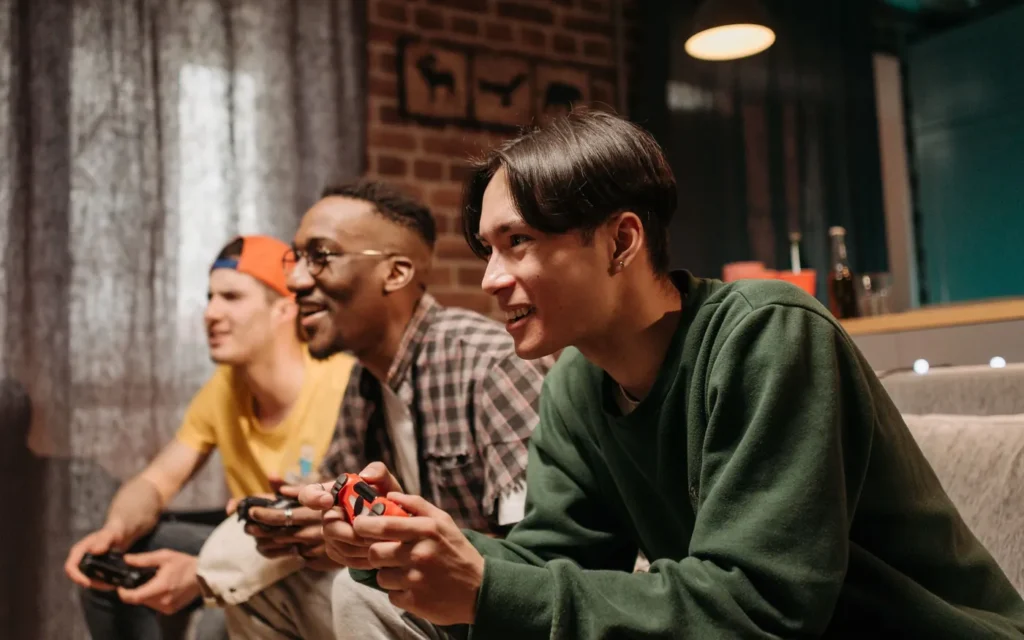 Group of friends enjoying video games together on a sofa