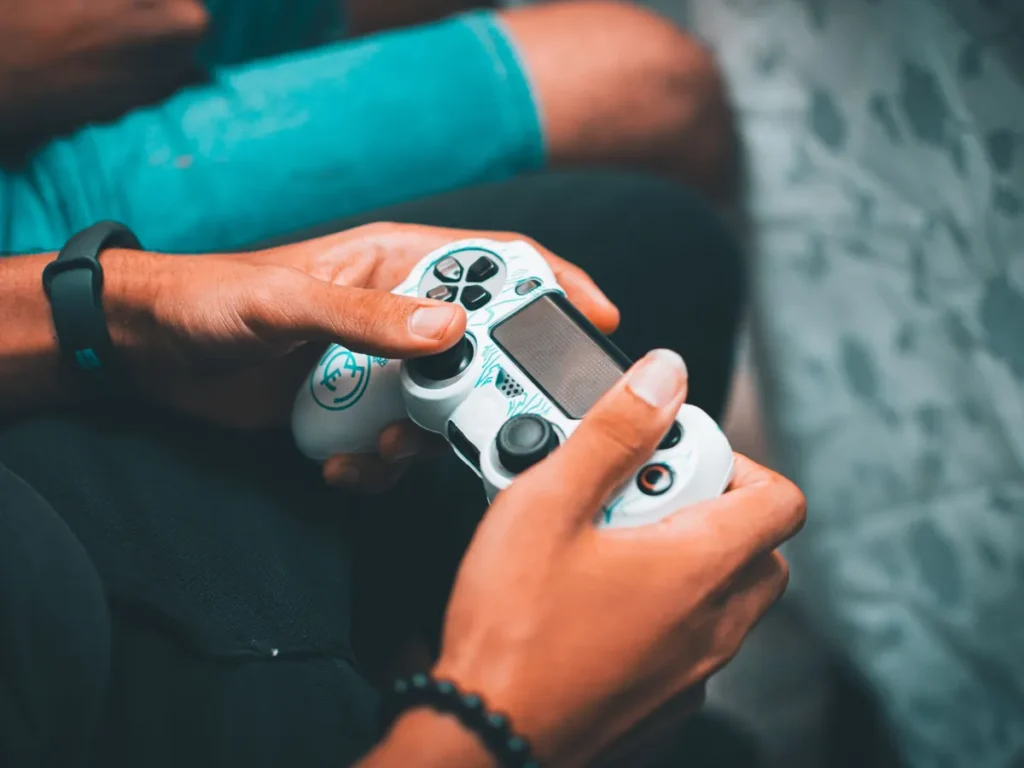 Hands holding a white game controller ready to play