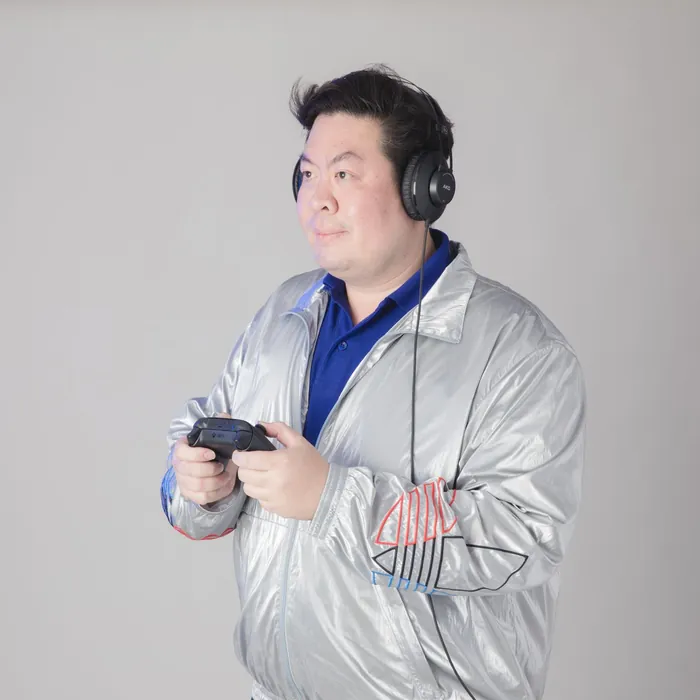 Gamer wearing headphones holding a game controller