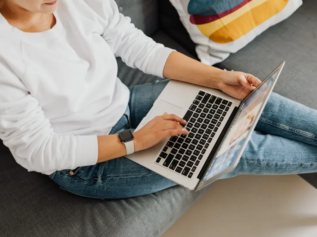 User browsing an online platform on a laptop at home