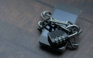 Padlock resting on a laptop keyboard, representing a locked online account being recovered