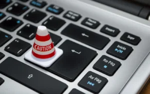 Person checking a login screen on a laptop for signs of a fake website